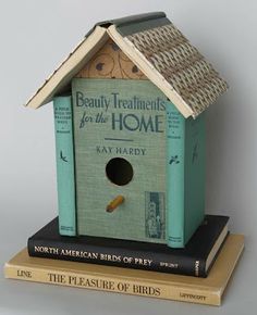 a bird house sitting on top of three books