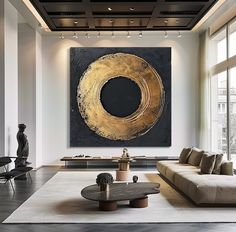 a living room filled with furniture and a large painting hanging on the wall above it