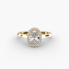 a yellow gold ring with an oval cut diamond in the center