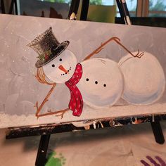 a snowman and two snowmen painted on a canvas