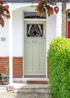 a green front door on a white house