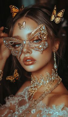 a beautiful woman wearing gold and silver butterfly mask with jewels on her face, posing for the camera