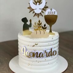 a white cake with gold decorations on top and the words dennardo above it