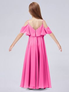 a woman in a pink dress with her back to the camera