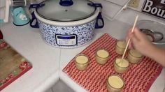 a person is stirring some food in front of an electric pressure cooker with chopsticks