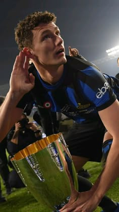 a rugby player holding the trophy in his hands