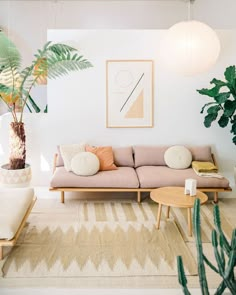 a living room filled with furniture and plants