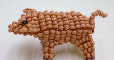 a beaded dog made out of beads on a white surface with text below it