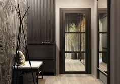 an entry way with wood paneling and glass doors