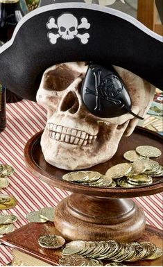 there is a pirate skull with a computer mouse in it's hat on top of coins