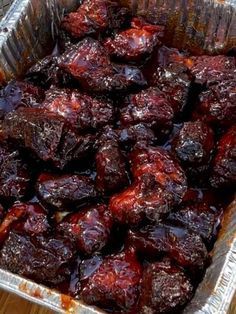 a pan filled with lots of food on top of a wooden table