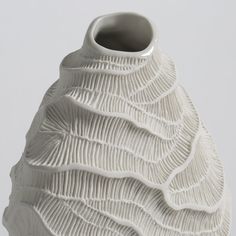 a white vase with wavy lines on it