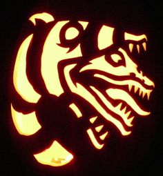 a carved pumpkin with an image of a dragon on it