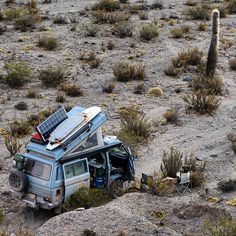 an suv is parked in the desert with its roof open