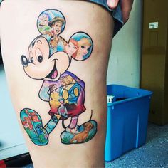 a person with a mickey mouse tattoo on their thigh