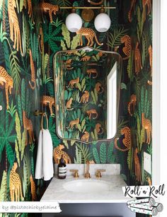 the bathroom is decorated with green and gold wallpaper, including giraffes