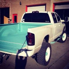 a white truck parked in front of a building