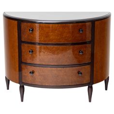 an oval wooden table with three drawers