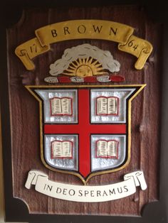 a wooden plaque with an emblem on it that says, brown hall in deo sperrumus