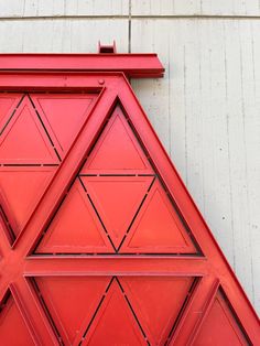 a close up of a red door on a building