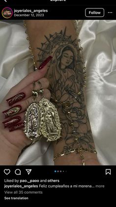 a woman's arm with tattoos on it and a rosary attached to the wrist