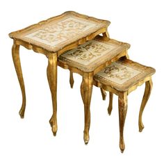 three small tables with gold leaf designs on each table and two smaller tables that are both side by side