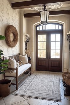 an entryway with a bench, rug and potted plants in front of the door