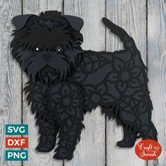 a black dog cut out on top of a wooden table