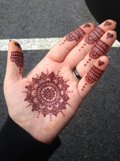 a woman's hand with hendix on it and hearts painted on the palm