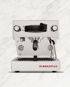 an espresso machine sitting on top of a marble counter