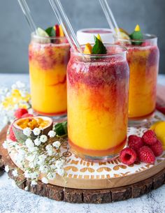 two glasses filled with raspberry slushie on top of a table