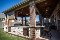 an outdoor kitchen and grill area in the back yard