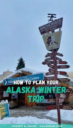 the alaska winter trip sign in front of a building with snow on the ground and trees