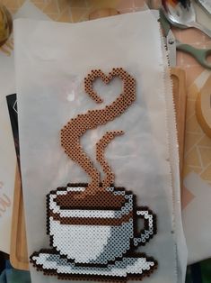 a piece of art made to look like a coffee cup with a heart on top