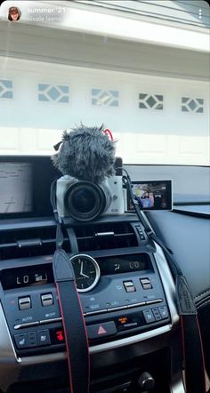 the interior of a car with an electronic device and camera attached to the dash board