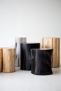 four different types of wooden stools sitting next to each other on a white floor