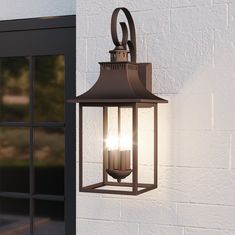 an outdoor light hanging on the side of a building