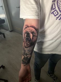 a man with a bear tattoo on his arm