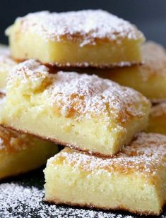 several pieces of cake sitting on top of a plate covered in powdered sugar and sprinkled with icing