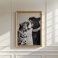 a black and white photo of a cat and a leopard in a frame on the wall