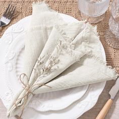 a place setting with napkins and silverware