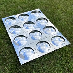 an image of a metal object on the ground with clouds in it's center