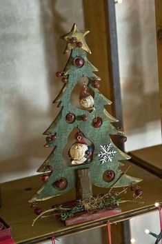 a small christmas tree with ornaments on it