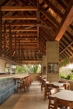 the inside of a restaurant with wooden tables and chairs