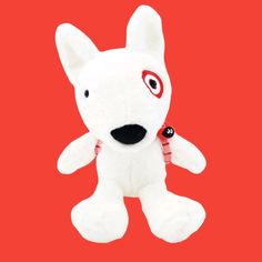 a white stuffed dog with red eyes and black nose on a red background is shown