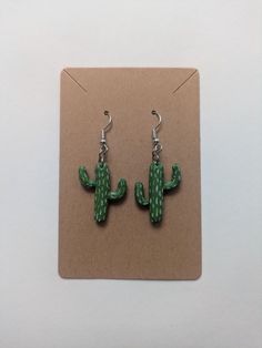 These cactus earrings are handmade out of polymer clay Cactus Earrings, Earring Ideas, Halloween Earrings, Jewelry Earrings Dangle, Etsy Earrings, Cactus, Polymer Clay, Dangle Drop Earrings, Dangle Earrings