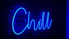 a blue neon sign that reads chilli on the side of a brick wall in a dark room