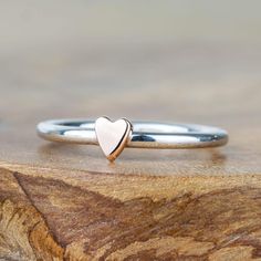 Featuring a gorgeous little solid 9ct rose gold or yellow gold heart perfectly polished upon a sterling silver band.  The heart rings stack perfectly together, or with other star, moon or gemstone rings.  Each piece is handmade in our small workshop in the village of Dounby on the Orkney Islands, a little island just off the top of Scotland.  You can choose to have the heart crafted in yellow gold or rose gold. Material - Made from solid sterling silver and solid 9ct yellow or rose gold. Hallmar Rose Gold Stackable Heart Ring For Valentine's Day, Stackable Rose Gold Heart Ring For Valentine's Day, Heart-shaped Rose Gold Stackable Rings As Gift, Rose Gold Heart-shaped Stackable Rings As Gift, Anniversary Rose Gold Stackable Heart Ring, Dainty Stackable Rose Gold Heart Ring, Heart-shaped Rose Gold Stackable Promise Rings, Rose Gold Heart-shaped Stackable Rings, Stackable Rose Gold Heart Promise Ring