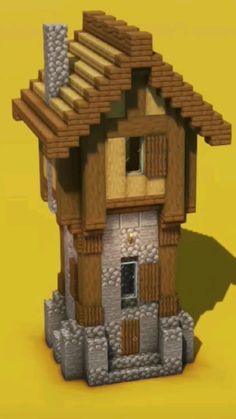 an image of a small house made out of legos on a yellow background with shadows