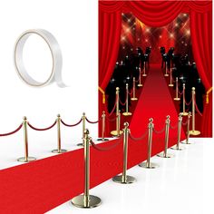 a red carpeted area with gold barriers and ropes